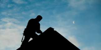 Bidding for the Water Services Department Roof Replacement Project To Open on August 12, 2024 Contractor in Silhouette working on a Roof Top